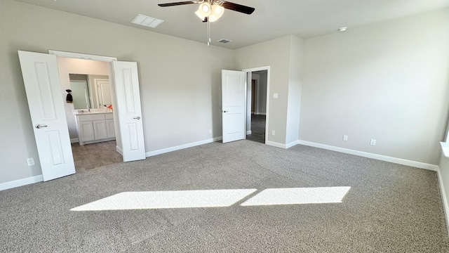 unfurnished bedroom with carpet floors, baseboards, and visible vents