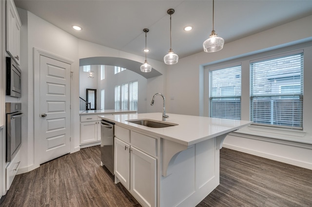 2009 Dappled Grey Ave, Aubrey, TX 76227 - kitchen with stainless steel appliances, arched walkways, dark wood finished floors, recessed lighting, and a center island with sink