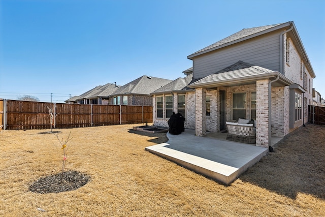 2009 Dappled Grey Ave, Aubrey, TX 76227 - back of house with a patio area, a fenced backyard, brick siding, and roof with shingles