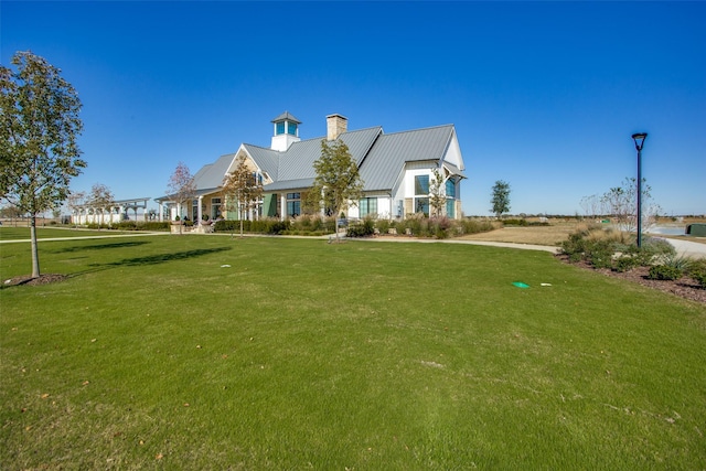 2009 Dappled Grey Ave, Aubrey, TX 76227 - view of front facade with a chimney, a front yard, and a metal roof