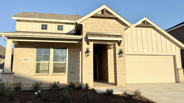 view of front facade featuring driveway, a shingled roof, board and batten siding, and an attached garage