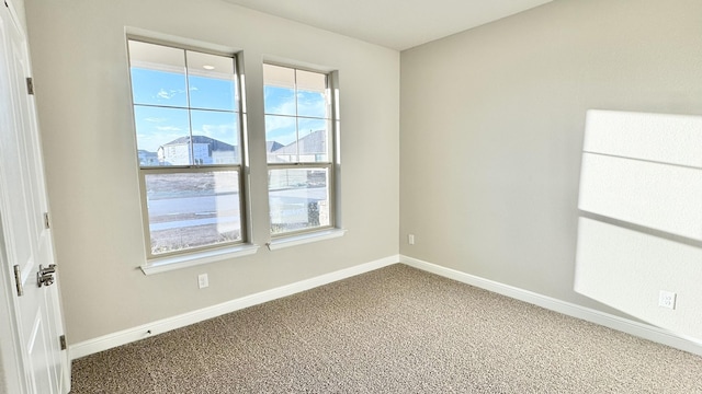 spare room with carpet flooring and baseboards