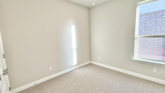 empty room with light carpet and baseboards