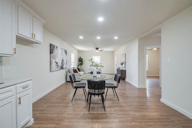 dining space featuring light wood-style flooring, recessed lighting, a ceiling fan, and baseboards