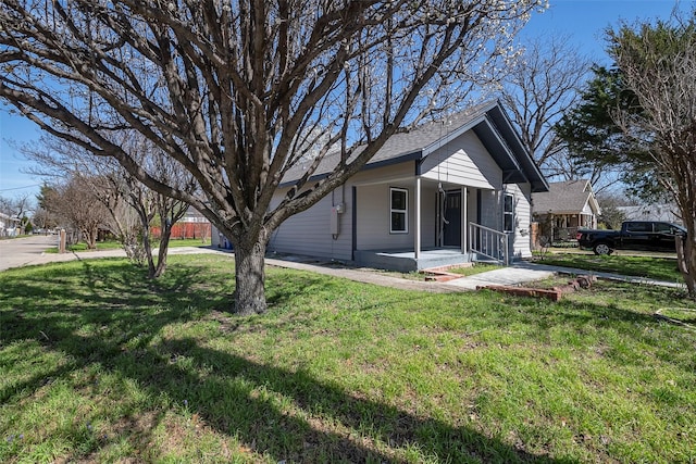 exterior space with covered porch and a lawn