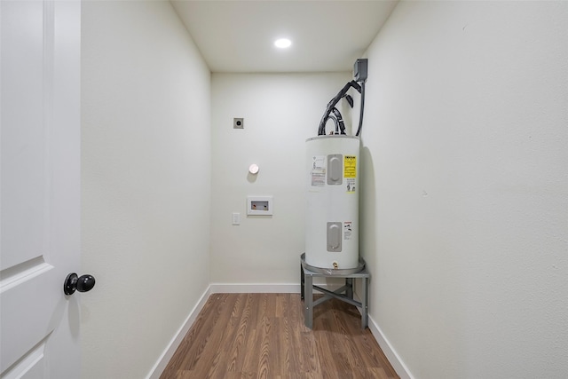 laundry area with electric water heater, washer hookup, laundry area, dark wood-style floors, and electric dryer hookup