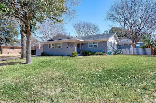 single story home with a garage, fence, a front lawn, and brick siding