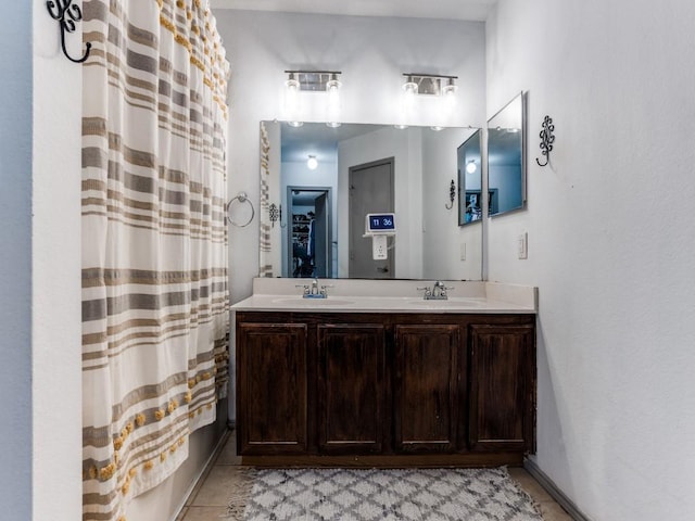 full bathroom with a shower with curtain, tile patterned floors, a sink, and double vanity