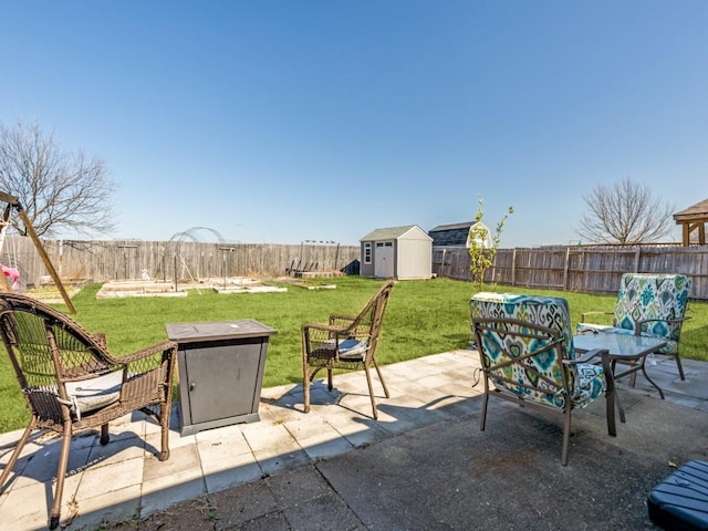 view of patio with a fenced backyard, an outdoor structure, and a shed