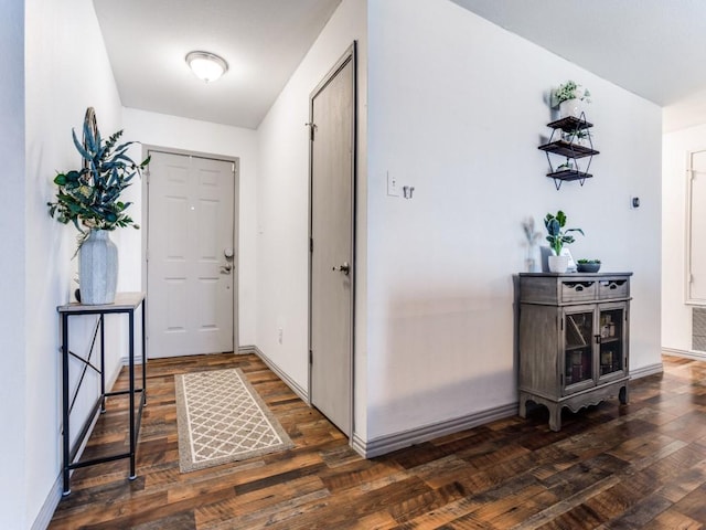 foyer featuring wood-type flooring, visible vents, and baseboards