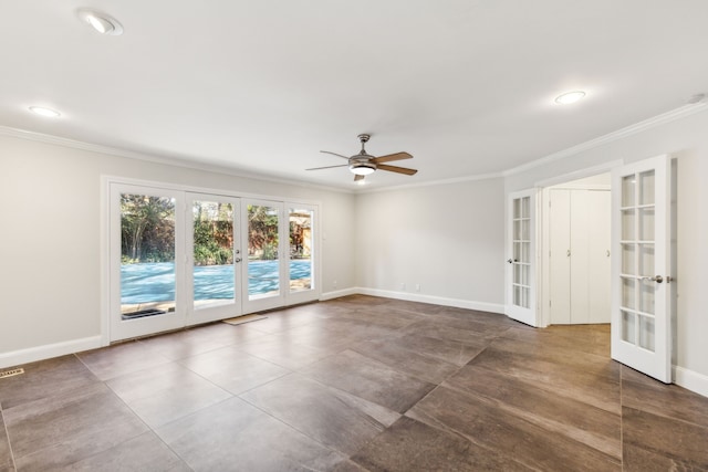 spare room with baseboards, ornamental molding, a ceiling fan, and french doors