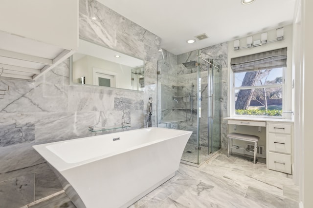 bathroom with marble finish floor, visible vents, a soaking tub, and a shower stall