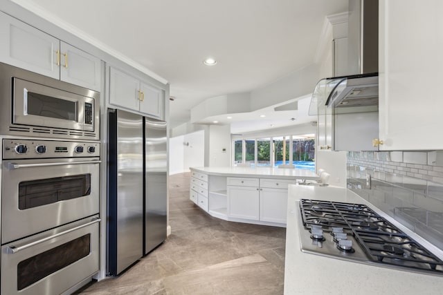 kitchen featuring open shelves, light countertops, backsplash, appliances with stainless steel finishes, and white cabinetry