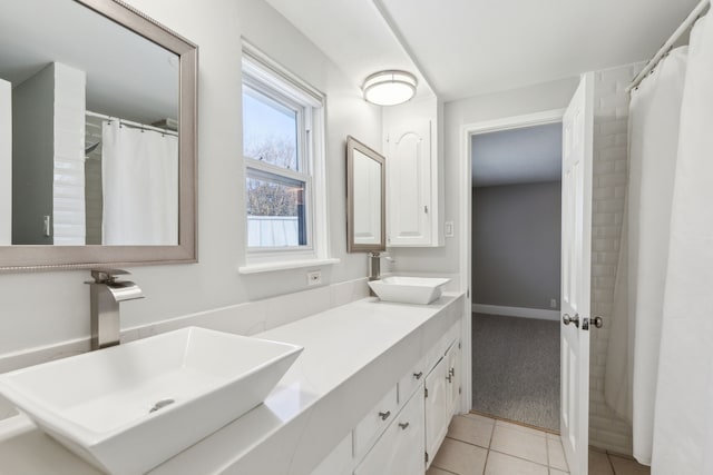 bathroom featuring double vanity, a sink, and tile patterned floors