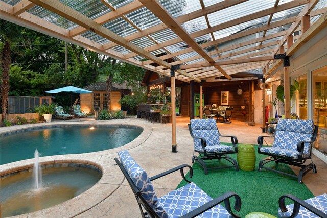 view of swimming pool with fence, an outdoor structure, a pergola, and outdoor dining space