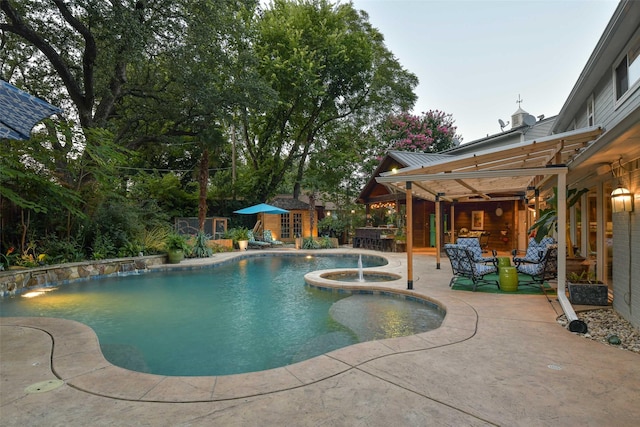 pool with an outbuilding, an in ground hot tub, a storage structure, and a patio