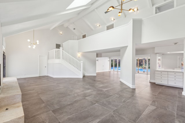 unfurnished living room featuring beam ceiling, visible vents, stairway, a chandelier, and baseboards