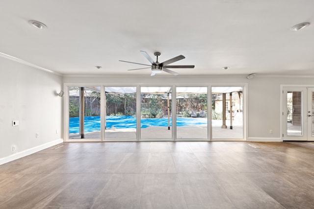 unfurnished room featuring crown molding, baseboards, a wealth of natural light, and french doors