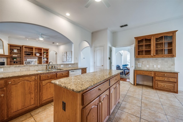 kitchen featuring a sink, backsplash, dishwasher, and ceiling fan