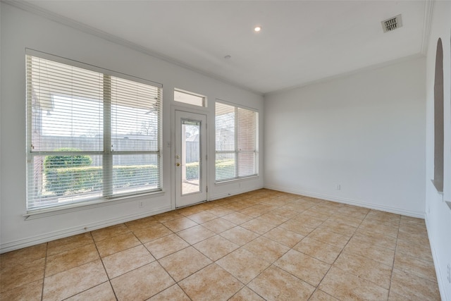 empty room featuring light tile patterned flooring, crown molding, visible vents, and baseboards