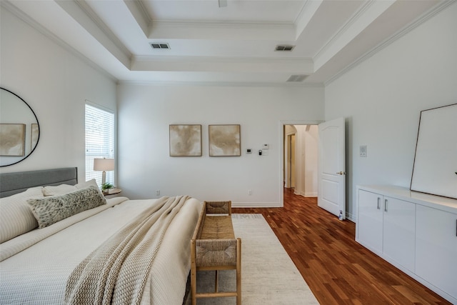 bedroom with crown molding, visible vents, a raised ceiling, and dark wood finished floors