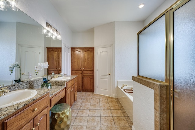 bathroom featuring tile patterned floors, double vanity, a sink, and a bath