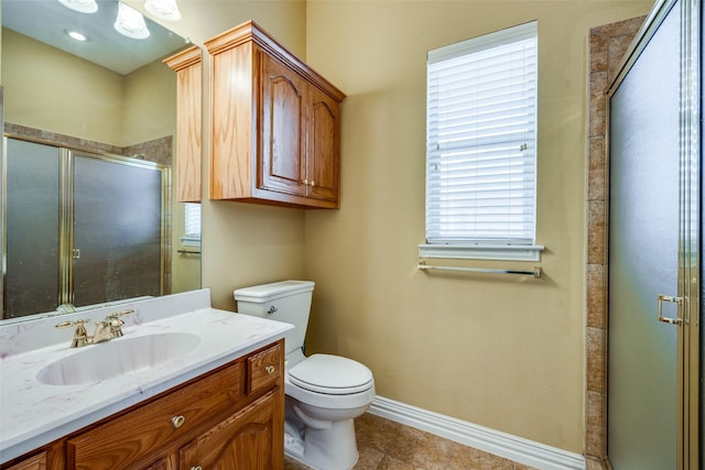 full bathroom with toilet, a shower stall, vanity, baseboards, and tile patterned floors