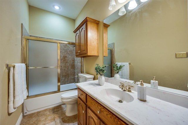 bathroom featuring toilet, shower / bath combination with glass door, and vanity