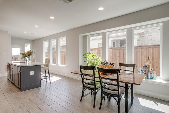 dining space featuring recessed lighting, light wood-style flooring, and a healthy amount of sunlight