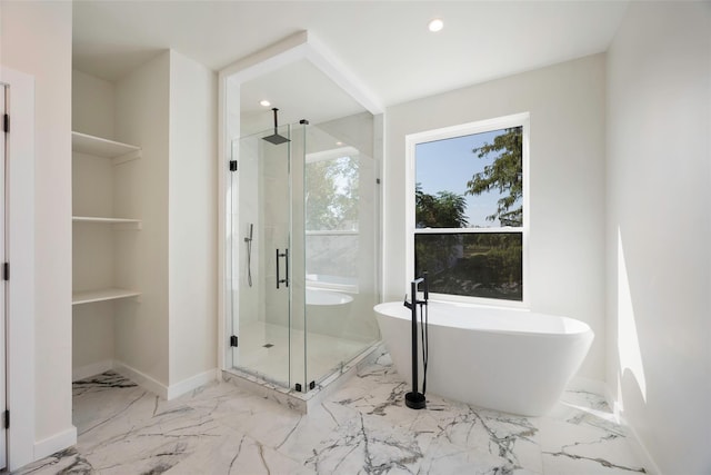 full bathroom featuring marble finish floor, recessed lighting, a shower stall, a freestanding tub, and baseboards