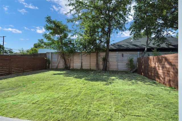 view of yard with a fenced backyard