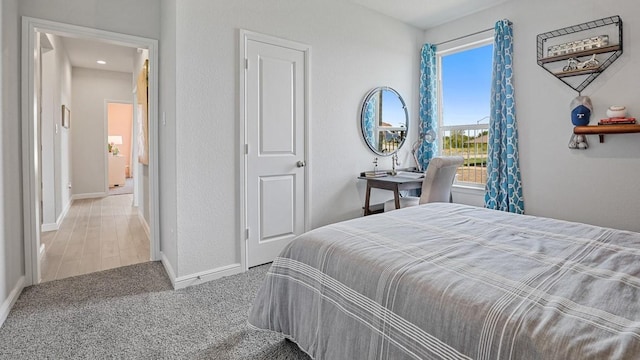 carpeted bedroom with baseboards