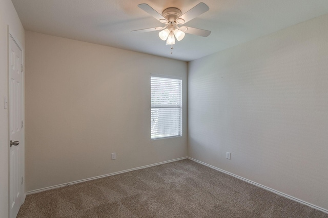 empty room featuring baseboards, a ceiling fan, and carpet flooring