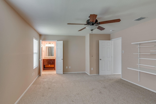 unfurnished bedroom with carpet flooring, visible vents, and baseboards