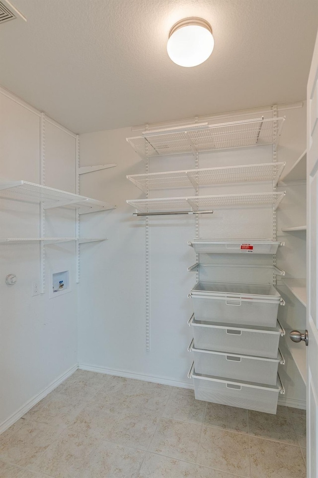 spacious closet featuring visible vents