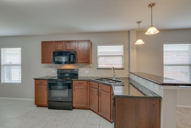 kitchen with black appliances, a sink, and brown cabinets