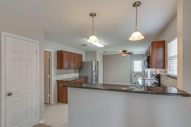 kitchen with electric range, stainless steel fridge with ice dispenser, brown cabinets, a peninsula, and black microwave