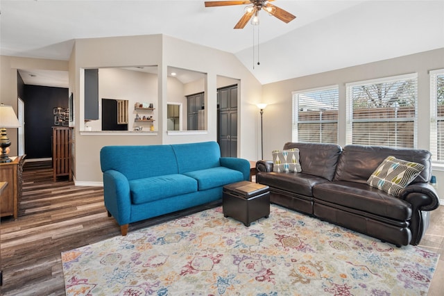 living area featuring ceiling fan, baseboards, vaulted ceiling, and wood finished floors