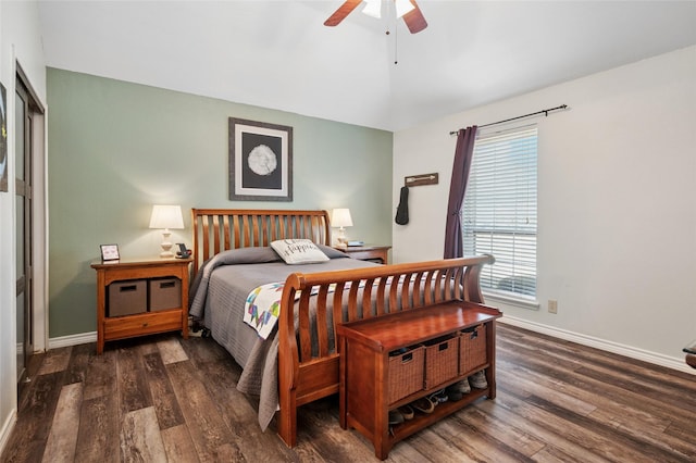 bedroom featuring a ceiling fan, lofted ceiling, baseboards, and wood finished floors