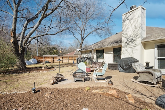 view of yard with an outdoor fire pit, a patio, and fence