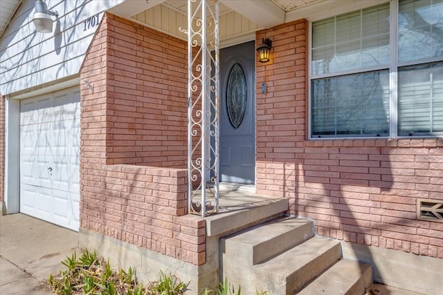 view of exterior entry featuring brick siding