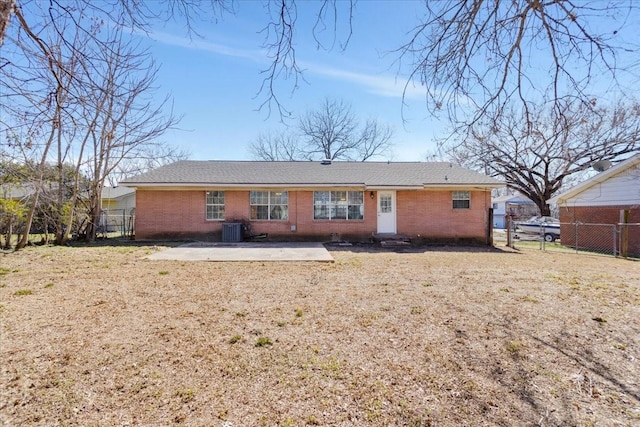 back of property with brick siding, a patio area, fence, and cooling unit