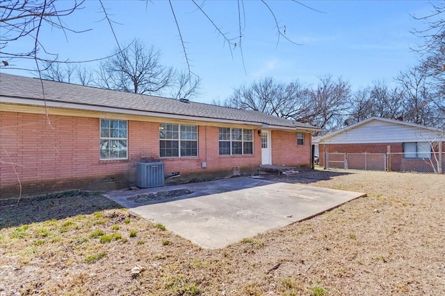 ranch-style house featuring a patio area, brick siding, fence, and central AC