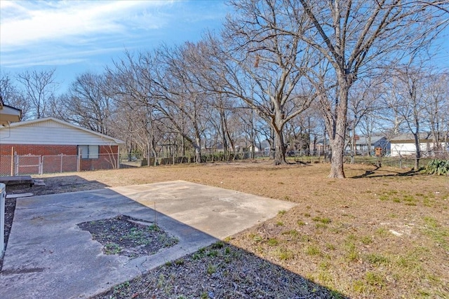 view of yard with driveway and fence