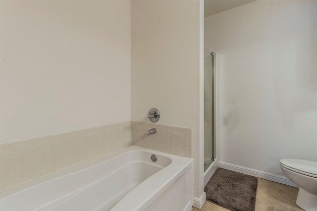 bathroom with a garden tub, toilet, a stall shower, tile patterned flooring, and baseboards