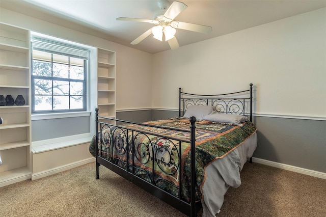 carpeted bedroom with ceiling fan and baseboards