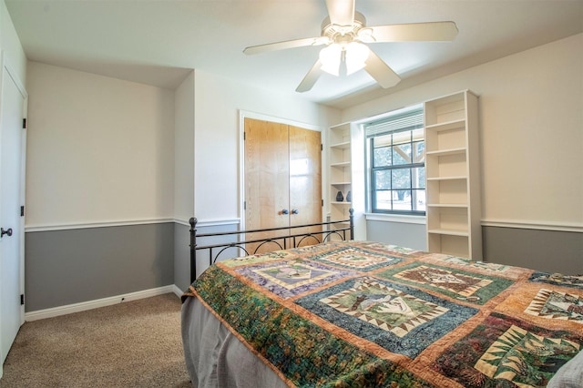 carpeted bedroom with a closet, baseboards, and a ceiling fan