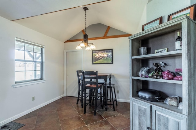 dining space with lofted ceiling, visible vents, a chandelier, dark tile patterned floors, and baseboards