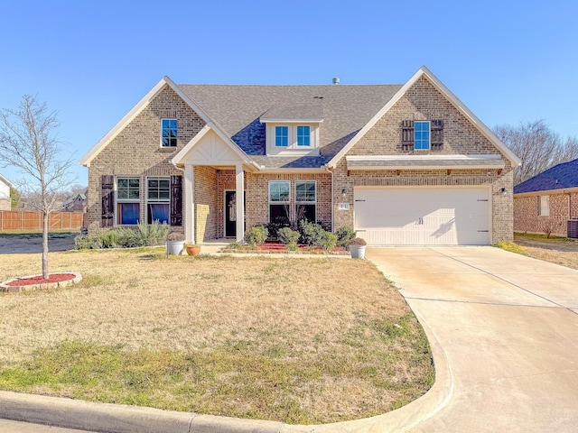 view of front of property featuring a garage, brick siding, fence, concrete driveway, and a front yard