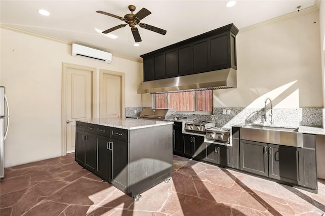 kitchen with ornamental molding, light stone countertops, marble finish floor, dark cabinetry, and a wall mounted AC